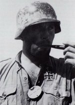 Oberstleutnant Georg Briel wearing Erkennungsmarke dogtag & Ritterkreuz while smoking from pipe.jpg