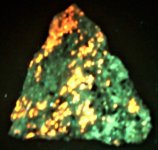 Sodalite syenite, Red Hill, Morltonborough, NH, FOV=2.5 in., filtered LWUV 365nm.JPG