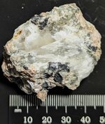 Calcite infilling a vug, tan syenite, GMQ#1, Pulaski Co., AR, natural light, coll. Jim Stoops.jpg