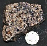 Calcite with fluorescent matrix , Franklin, Sussex Co., NJ, US dime for scale, reverse, natura...JPG