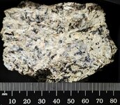 Thin calcite coating orthoclase syenite, GMQ#1, Pulaski Co., AR, natural light.jpg