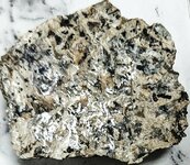 Calcite cleavage reflection on orthoclase syenite, GMQ#1, Pulaski Co., AR, natural light.jpg