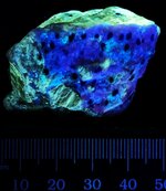 Lazurite spots in sodalite on phlogopite, Badakhshan, Afghanistan, MW 310nm.jpg